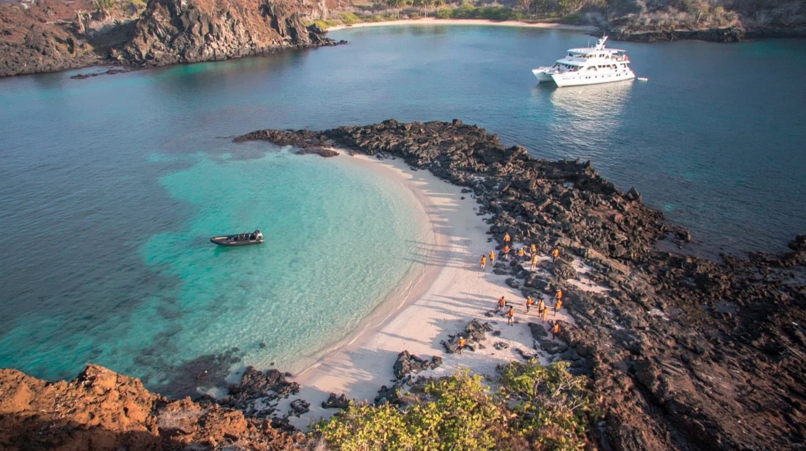 A 16-passenger expedition catamaran anchored close to a remote landing site.